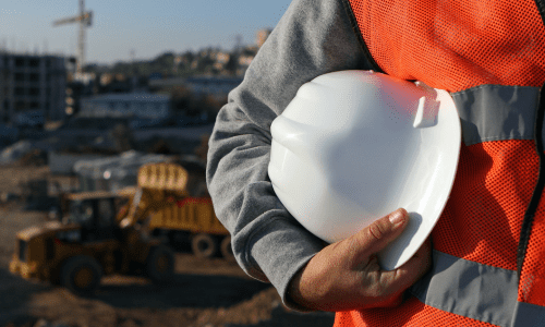 worker holding a white service hard hat